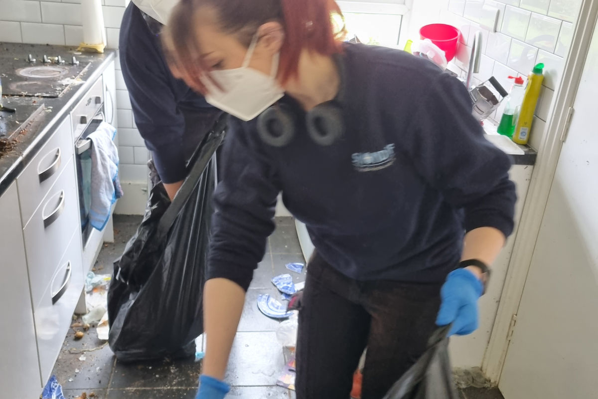 Clearance team member carefully bagging contents during a bereavement clearance